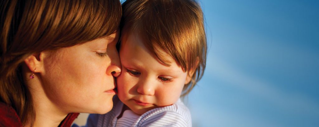 a mother holding her child close to her face