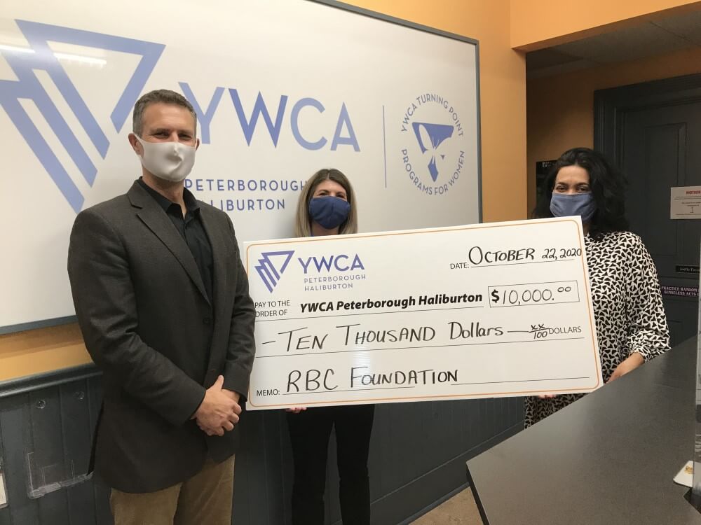 YWCA's Ria Nicholson accepting a cheque for $10,000 from representatives of RBC Foundation