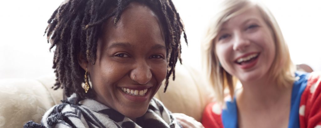 Image of two smiling young women sitting together