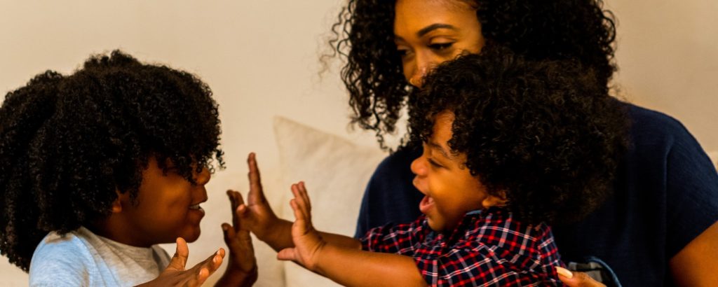 two young children playing with their mom
